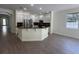 Spacious kitchen featuring an island with granite counters, stainless steel appliances, and white cabinets at 9516 Piccadilly Sky Way, Orlando, FL 32827