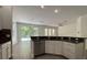 Modern kitchen featuring stainless steel appliances and white cabinetry with a view of the patio at 9516 Piccadilly Sky Way, Orlando, FL 32827