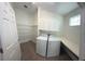 Well-organized laundry room with washer, dryer, shelving, and storage at 9516 Piccadilly Sky Way, Orlando, FL 32827