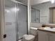 Bright bathroom with a shower and tub combo, white toilet, and large mirror at 1119 Park Ridge Cir, Kissimmee, FL 34746