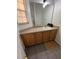 Bathroom featuring neutral colored laminate countertops, a white sink, and vinyl flooring at 1119 Park Ridge Cir, Kissimmee, FL 34746