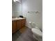 Well-lit bathroom featuring a vanity with a sink, modern fixtures, and a toilet at 1119 Park Ridge Cir, Kissimmee, FL 34746