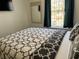 Bedroom with a bed, matching pillows, and a TV on the wall at 1119 Park Ridge Cir, Kissimmee, FL 34746