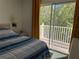 Bedroom with a sliding glass door to the balcony at 1119 Park Ridge Cir, Kissimmee, FL 34746