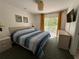 Bedroom featuring a queen bed, balcony access, and a dresser at 1119 Park Ridge Cir, Kissimmee, FL 34746