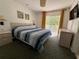 Bedroom showcasing a queen bed, balcony access, and neutral furnishings at 1119 Park Ridge Cir, Kissimmee, FL 34746