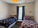 Cozy bedroom featuring two twin beds, a central table, and neutral decor at 1119 Park Ridge Cir, Kissimmee, FL 34746