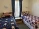 Bright bedroom showcasing twin beds, neutral decor, and ample natural light at 1119 Park Ridge Cir, Kissimmee, FL 34746