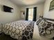 Bedroom with a bed, matching pillows, and a TV on the wall at 1119 Park Ridge Cir, Kissimmee, FL 34746