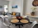 Cozy dining area featuring luxury vinyl plank flooring, modern furniture, and beach themed artwork at 1119 Park Ridge Cir, Kissimmee, FL 34746