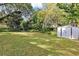 The large backyard is surrounded by mature trees, providing a private and tranquil outdoor oasis at 112 E Coleman Cir, Sanford, FL 32773