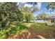Lush backyard with mature trees, green grass, and shed perfect for outdoor enjoyment and storage at 112 E Coleman Cir, Sanford, FL 32773