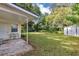 View of the backyard showcasing a lush lawn, mature trees, and a storage shed for extra convenience at 112 E Coleman Cir, Sanford, FL 32773