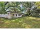 Large backyard with mature trees and well-maintained lawn, creating a serene outdoor space at 112 E Coleman Cir, Sanford, FL 32773