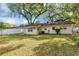 Expansive backyard featuring a well-maintained lawn and mature trees offering ample shade and privacy at 112 E Coleman Cir, Sanford, FL 32773