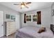 Bedroom featuring a neutral color palette, natural light from a window, and comfortable furnishings at 112 E Coleman Cir, Sanford, FL 32773