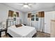 Bedroom with a neutral color palette, a bed with decorative pillows, and windows at 112 E Coleman Cir, Sanford, FL 32773