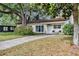 Charming home with a well-maintained lawn and mature trees providing shade and curb appeal at 112 E Coleman Cir, Sanford, FL 32773