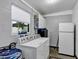 Functional laundry room with washer, dryer, ample storage, and bright window at 112 E Coleman Cir, Sanford, FL 32773