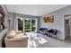 Bright living room featuring large window, terrazzo flooring, and stylish contemporary furnishings at 112 E Coleman Cir, Sanford, FL 32773