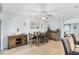 Spacious dining room with wooden table, chairs, bar area, stylish lighting, and hardwood flooring at 13034 Royal Fern Dr, Orlando, FL 32828