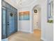 Bright foyer with a decorative chandelier, glass-paneled front door, and an arched entryway at 13034 Royal Fern Dr, Orlando, FL 32828