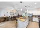 Open-concept kitchen and dining area with stainless steel appliances, granite counters, and pendant lighting above the bar at 13034 Royal Fern Dr, Orlando, FL 32828