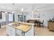 Open-concept kitchen with granite countertops, modern appliances, and a spacious island at 13034 Royal Fern Dr, Orlando, FL 32828