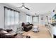 Spacious living room with hardwood floors, comfortable leather seating, and lots of natural light at 13034 Royal Fern Dr, Orlando, FL 32828