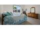 Inviting bedroom with a charming wooden dresser and a large window that provides a view of the outdoors at 13133 Sunny Retreat Ln, Winter Garden, FL 34787