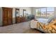 Comfortable bedroom with wood-look flooring, an armoire, and plenty of natural light from the window at 13133 Sunny Retreat Ln, Winter Garden, FL 34787