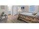 Bedroom with wood-look tile floors, ensuite bathroom, large window, and stylish decor at 13133 Sunny Retreat Ln, Winter Garden, FL 34787