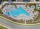 Aerial view of a stunning community pool with lounge chairs, landscaping, and a jacuzzi at 13133 Sunny Retreat Ln, Winter Garden, FL 34787