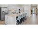 Bright, open kitchen features stainless appliances, an island with seating, and stylish backsplash at 13133 Sunny Retreat Ln, Winter Garden, FL 34787