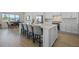 Modern kitchen island with seating, quartz countertops, stainless appliances, and tile backsplash at 13133 Sunny Retreat Ln, Winter Garden, FL 34787