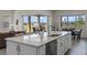Kitchen island with quartz countertop, stainless steel appliances, and views of the patio at 13133 Sunny Retreat Ln, Winter Garden, FL 34787