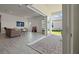 Open living room with tile flooring, comfortable seating, and seamless access to the outdoor patio at 13133 Sunny Retreat Ln, Winter Garden, FL 34787