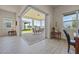 Open patio with a dining set and views of the spacious backyard and neighboring houses at 13133 Sunny Retreat Ln, Winter Garden, FL 34787