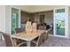 Covered patio with brick pavers, dining table, and access to the kitchen and living room through sliding glass doors at 13133 Sunny Retreat Ln, Winter Garden, FL 34787