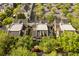 Aerial view of townhomes featuring dark roofs and surrounded by mature trees and parking areas at 1316 Lake Baldwin Ln, Orlando, FL 32814