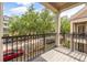 Outdoor balcony with black wrought iron railing overlooking street with trees and vehicles at 1316 Lake Baldwin Ln, Orlando, FL 32814