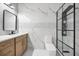 Bright bathroom featuring marble tile, a modern vanity, and a frameless glass shower with matte black trim at 1316 Lake Baldwin Ln, Orlando, FL 32814