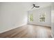 Light, airy bedroom with hardwood floors, two large windows, and a ceiling fan at 1316 Lake Baldwin Ln, Orlando, FL 32814