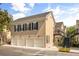 Exterior view of townhome featuring a three-car garage and stylish architectural details at 1316 Lake Baldwin Ln, Orlando, FL 32814