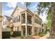 Exterior view of a two-story home with a balcony, black shutters, and manicured landscaping at 1316 Lake Baldwin Ln, Orlando, FL 32814