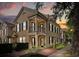 Charming two-story townhome featuring black shutters, a balcony, and well-maintained landscaping at dusk at 1316 Lake Baldwin Ln, Orlando, FL 32814
