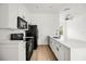Modern kitchen featuring white cabinets, quartz countertops, and stainless steel appliances at 1316 Lake Baldwin Ln, Orlando, FL 32814