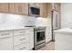 Modern kitchen showcasing stainless steel appliances and marble backsplash at 1316 Lake Baldwin Ln, Orlando, FL 32814