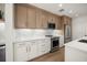 Bright kitchen featuring stainless steel appliances, marble backsplash, and wood-style cabinetry at 1316 Lake Baldwin Ln, Orlando, FL 32814
