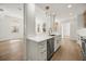 Open-concept kitchen and living area with an island and stainless steel appliances at 1316 Lake Baldwin Ln, Orlando, FL 32814